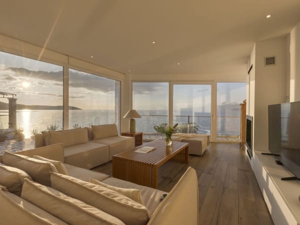 Walls of windows and glass doors make the very most of the unforgettable sea views.